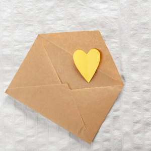 Yellow Heart coming out of an envelop