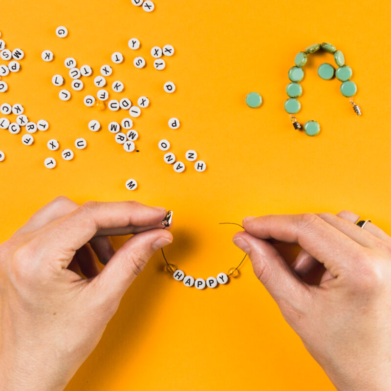 Hands making bracelets